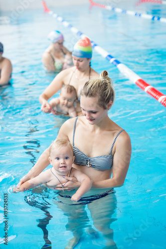 a small child with his mother in the pool