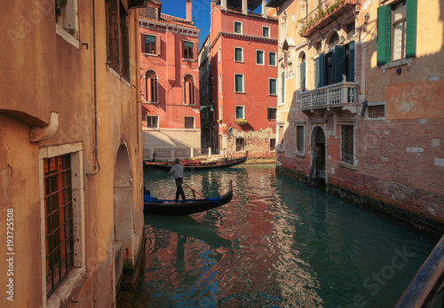 Narrow Venice channel with gondoliers. Italy.