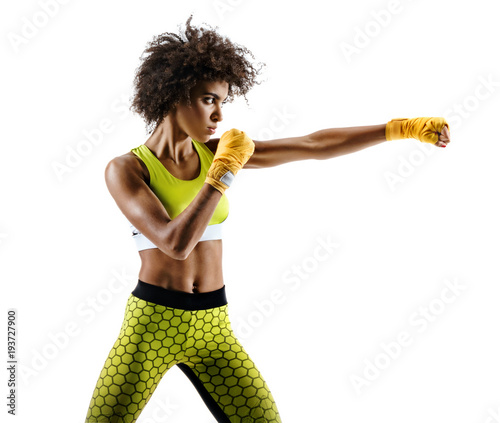 Boxer woman making direct hit. Photo of sporty african woman during boxing on white background. Dynamic movement. Side view