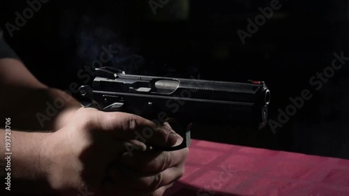 Close up of 9 mm handgun. Shooting at super slow motion 500FPS