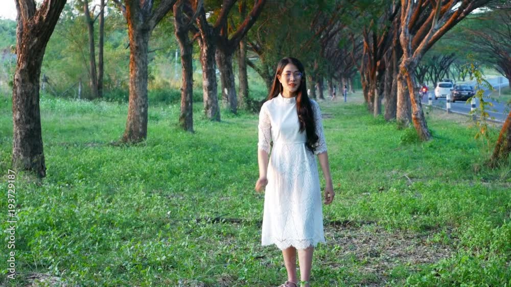 4k of beautiful woman standing in the park 4k of beautiful woman standing in the park