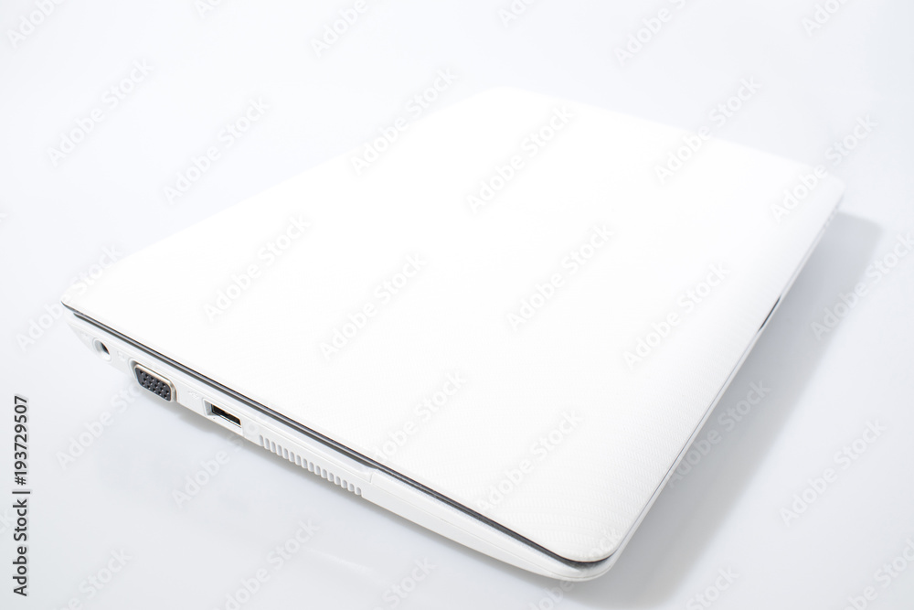 White laptop in a white background composition White laptop in a white background composition
