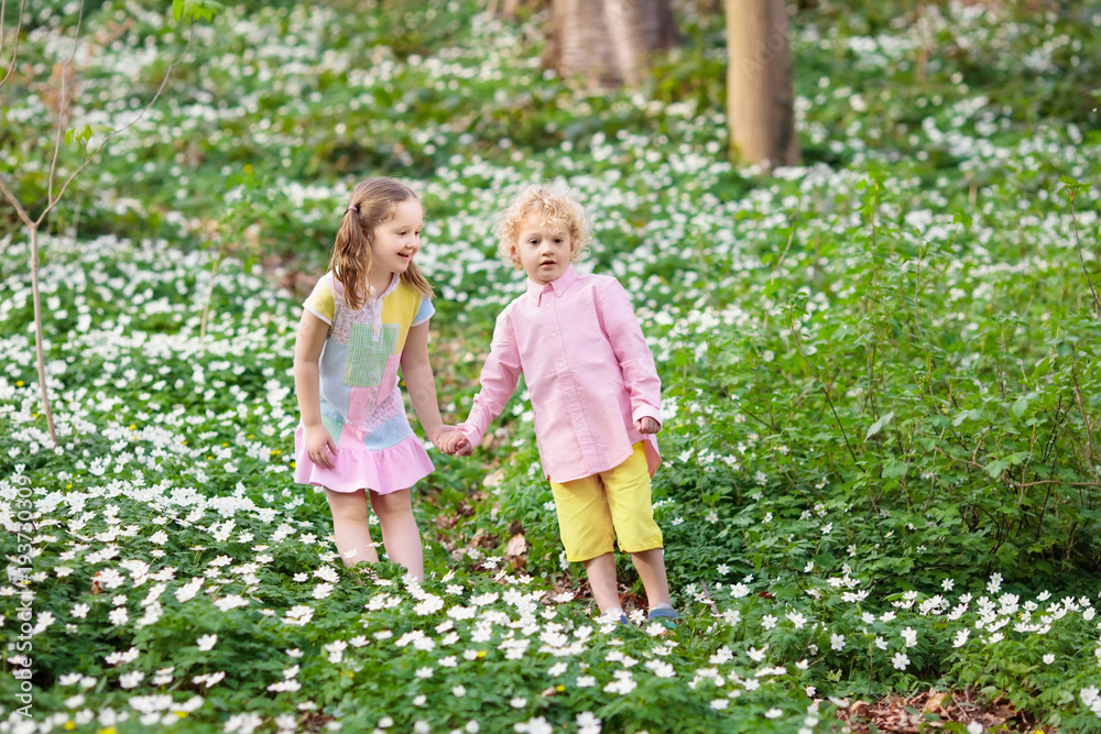 Children in spring park with flowers Children in spring park with flowers