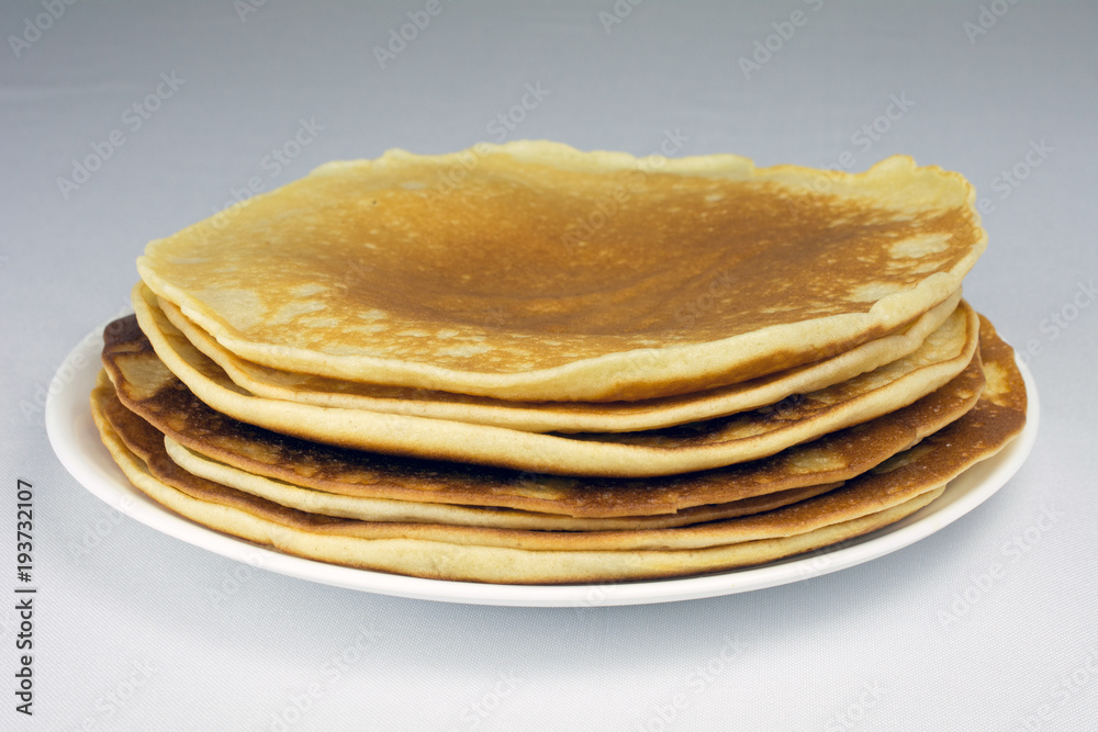 stack of pancakes on a white plate selective focus, white background,