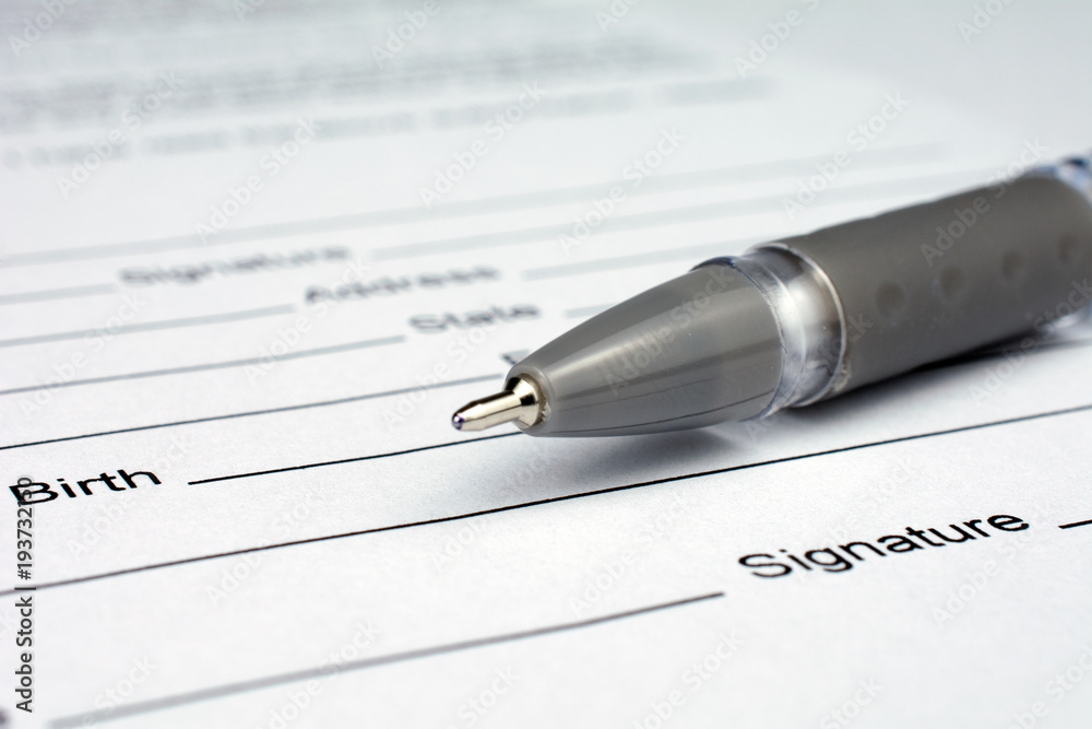 pen laying over a contract waiting to be signed pen laying over a contract waiting to be signed