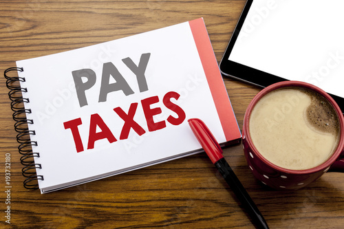 Handwriting Announcement text showing Pay Taxes. Business concept for Taxation Overtax Return Written on notepad note paper on wooden background with space office view with pencil marker