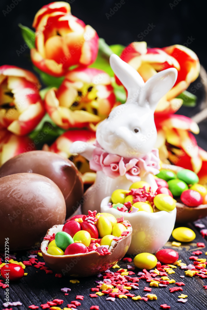 Easter composition with a rabbit and flowers, dark background, selective focus