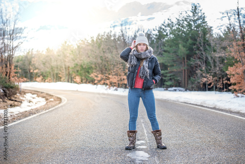 Young pretty woman on a road with snow in winter © DavidPrado
