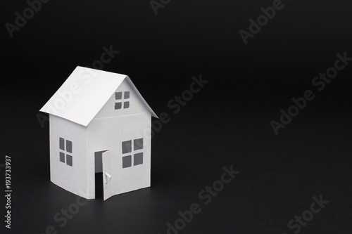 white small house on blurred dark background, close up, selective focus Real Estate concept