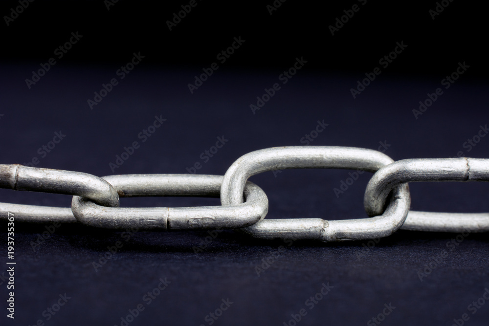 chain on a black background close-up of a selective focus chain on a black background close-up of a selective focus