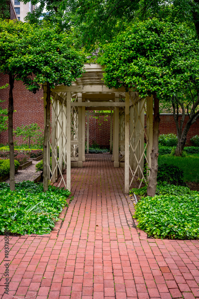 atrium with brick path leads through a garden