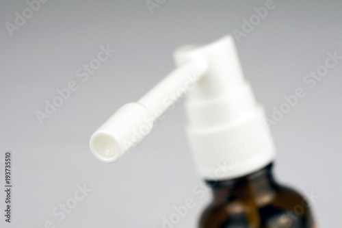 cough spray treatment of sore throat blurred neutral background selective focus