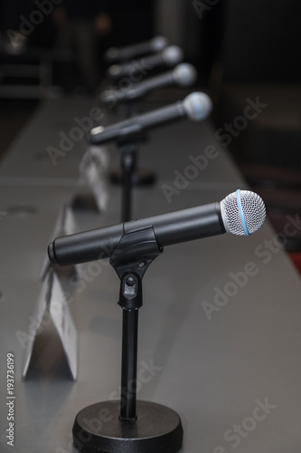 Microphones in press conference room, prepared for press conference.