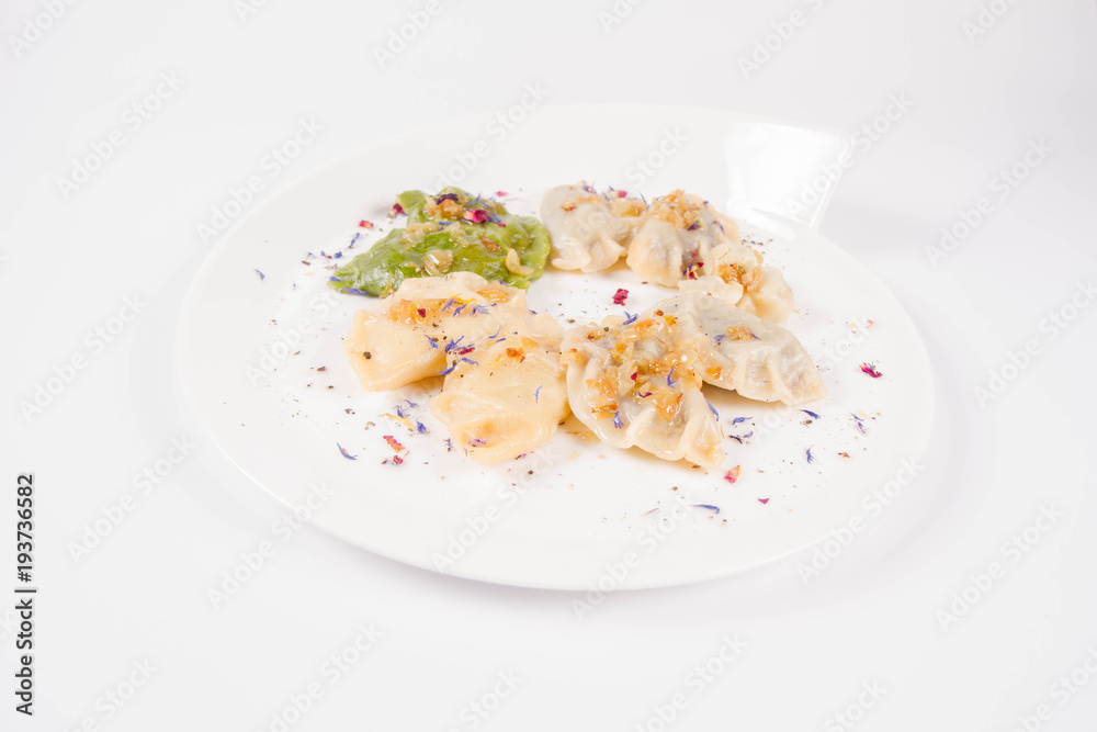 Dumplings with different kinds of stuffing decorated on a plate Dumplings with different kinds of stuffing decorated on a plate