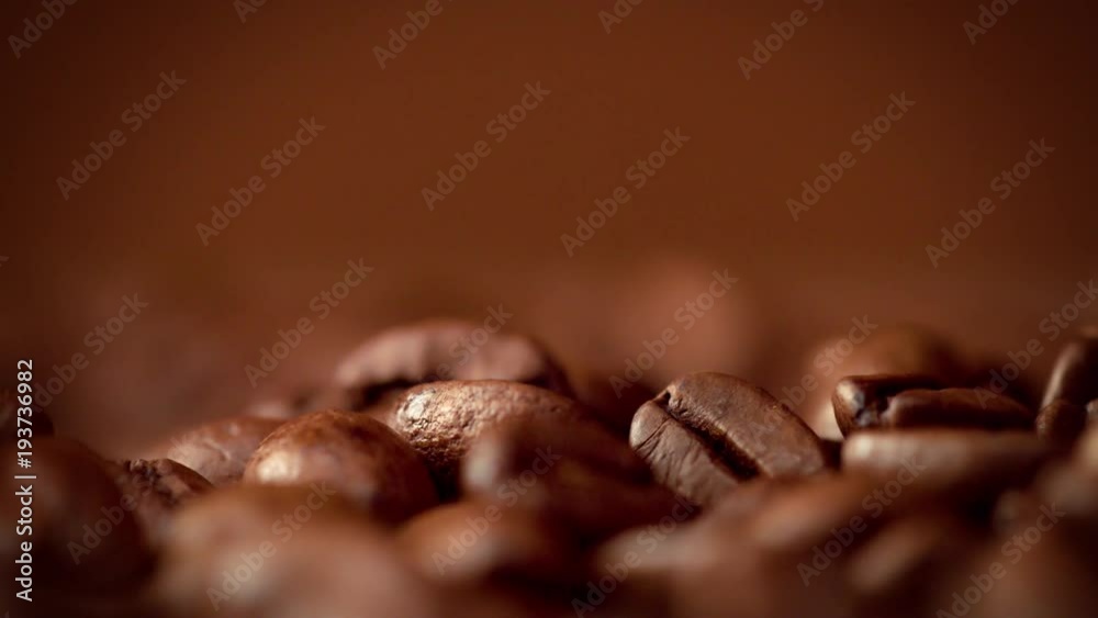 macro of coffee beans slowmotion falling in studio