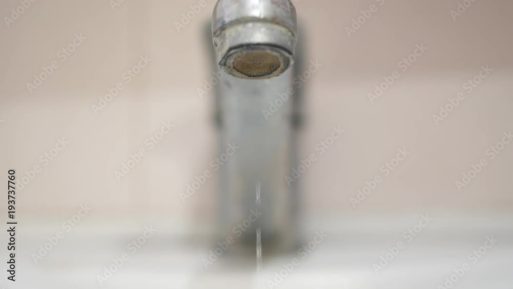Rusty faucet flows. Concept of waste of water resources. Drops flow slowly. Slow Motion 120fps Rusty faucet flows. Concept of waste of water resources. Drops flow slowly. Slow Motion 120fps