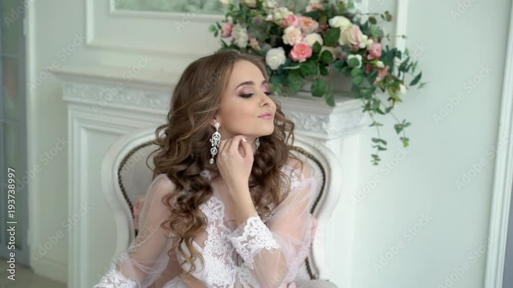 Young beautiful woman posing in white lingerie slowmotion Young beautiful woman posing in white lingerie slowmotion