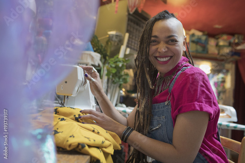 Portrait of smiling young female designer working at studio