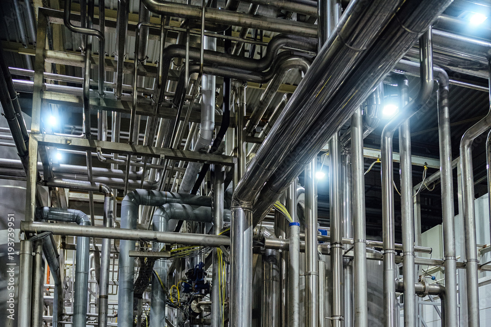 Industrial pipeline system in brewery for ingredient transportation. Abstract industrial pipeline background Industrial pipeline system in brewery for ingredient transportation. Abstract industrial pipeline background