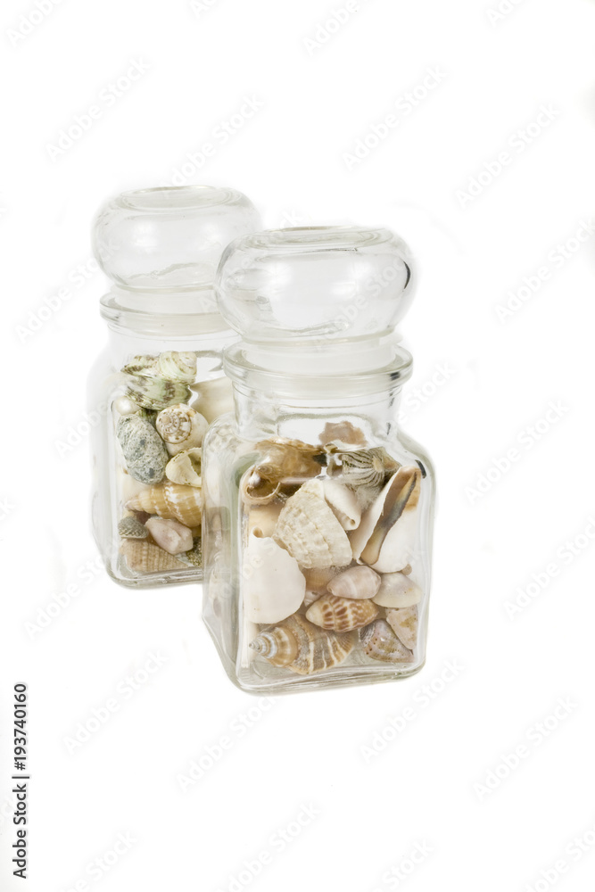 a glass container full of shells on a white isolated background a glass container full of shells on a white isolated background
