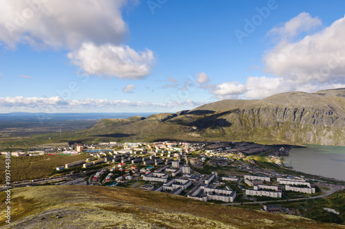 Russian polar town Kirovsk, Murmansk region. View from the mountain Aikuaiventchorr. Lake Bolshoy Vudyavr on the right. Mountain Vudyavrchorr on the background. photo