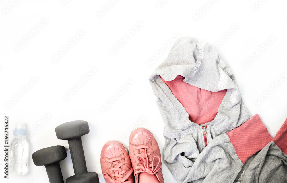 Top view fitness and sports clothes and accessories for females on white background: Sneakers, headphones, cell phone, dumbbells - obrazy, fototapety, plakaty 