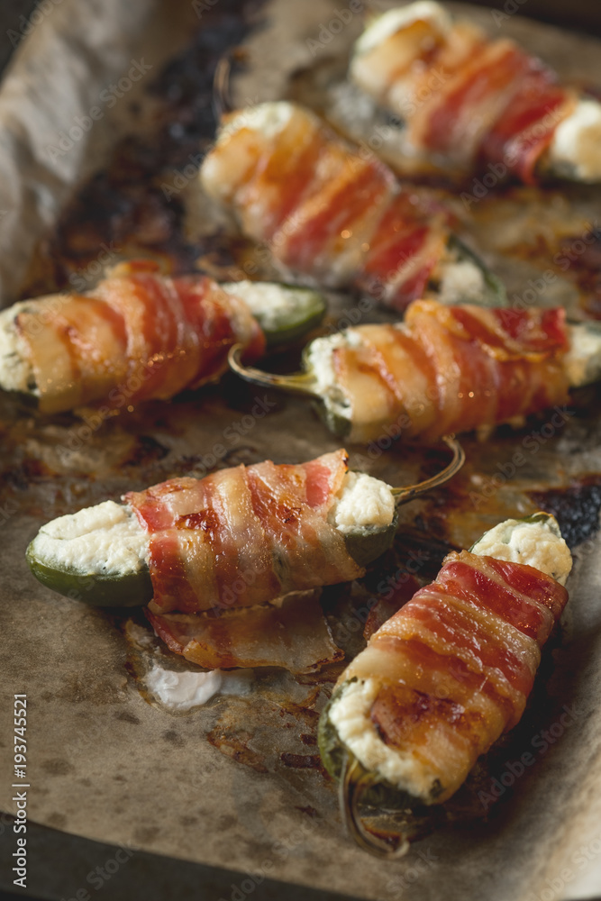Vegetables stuffed with cheese and bacon and baked on tray in oven. Rustic recipe food on wooden background. Top view Vegetables stuffed with cheese and bacon and baked on tray in oven. Rustic recipe food on wooden background. Top view
