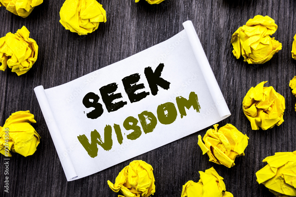 Fototapeta premium Writing text showing Seek Wisdom. Business concept for Inspiration Knowledge Written on sticky note notepad note notebook book wooden background with yellow sticky folded.