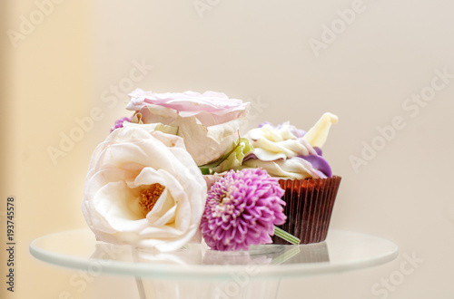 A delicious cupcake and flowers. Concept party, wedding, restaurant, catering, dessert.
