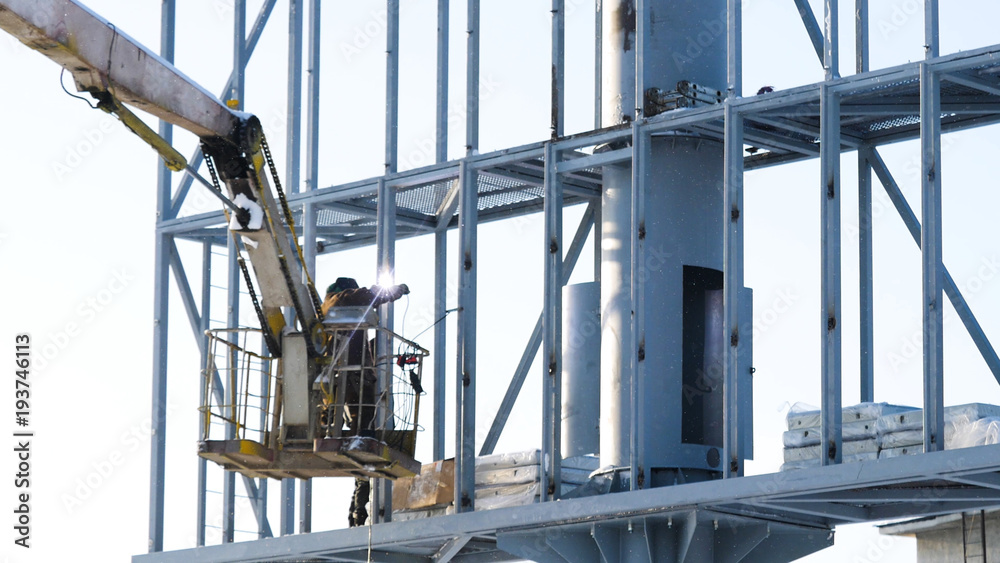 Steel structure for an advertising banner on the wall. construction site and blank billboard and blue sky