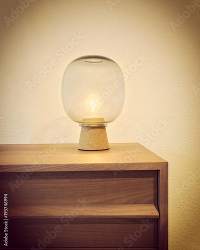 Retro style glass lamp on a wooden dresser