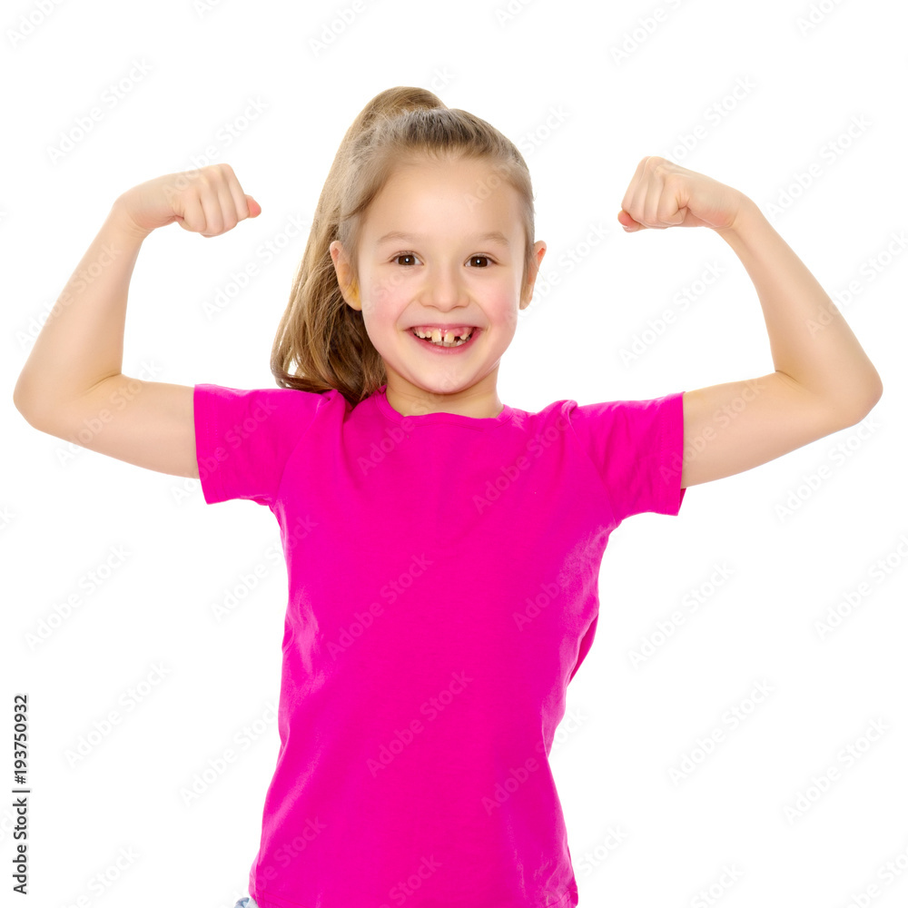 A little girl shows her muscles. A little girl shows her muscles.