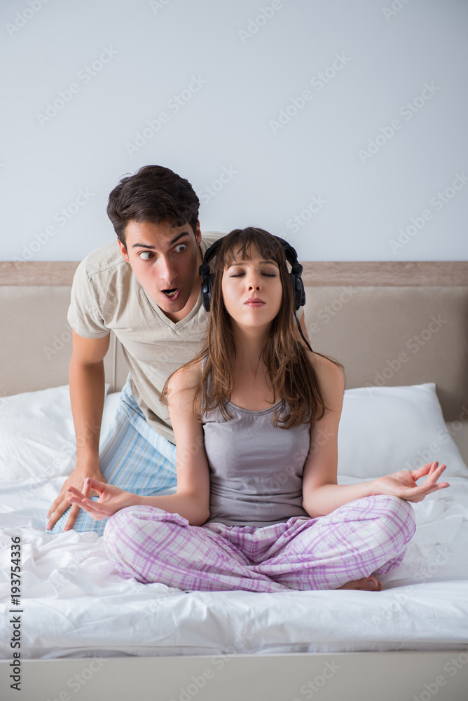 Young family meditating in the bed bedroom Young family meditating in the bed bedroom