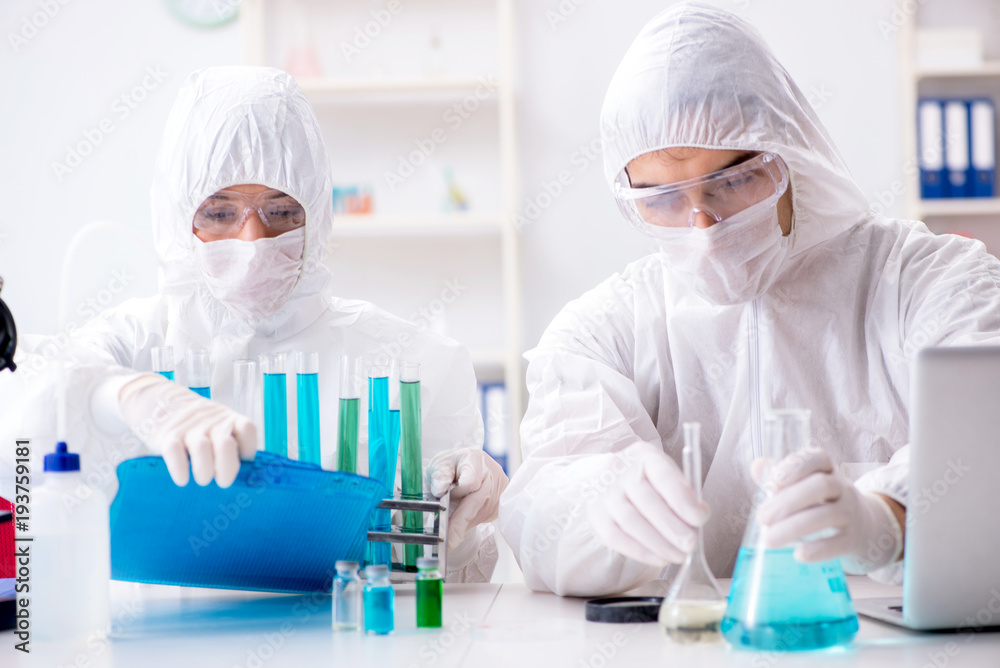 Two chemists working in the lab Two chemists working in the lab