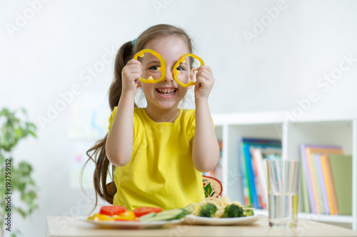 child girl eats vegan food ...