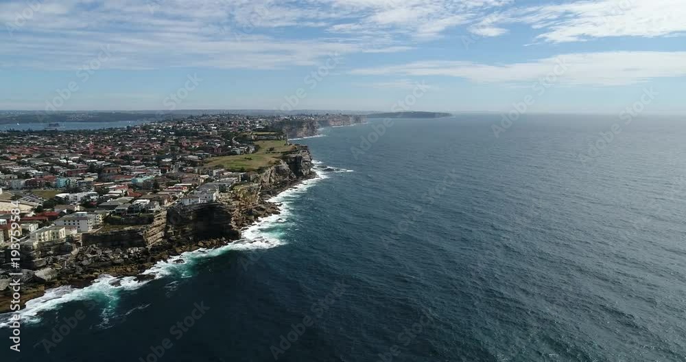 Distant elevated rotation off North Bondi head showing wide panorama of Sydney coast facing Pacific ocean with city CBD on horizon
Distant elevated rotation off North Bondi head showing wide panorama of Sydney coast facing Pacific ocean with city CBD on horizon