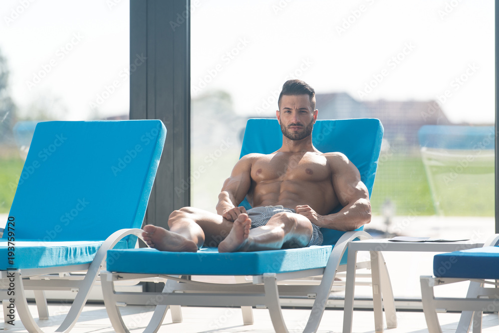 Young Man Lying On A Sun Lounger