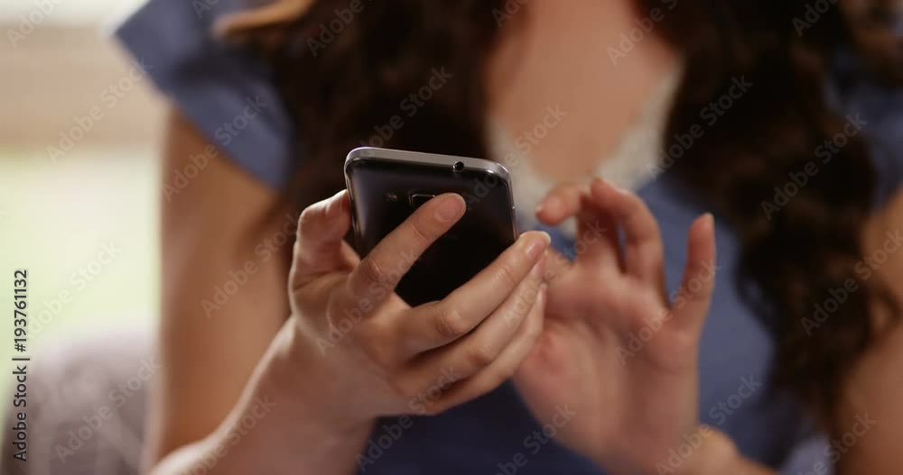 4k, Attractive young woman relaxing at home and chatting on her mobile phone. 4k, Attractive young woman relaxing at home and chatting on her mobile phone.