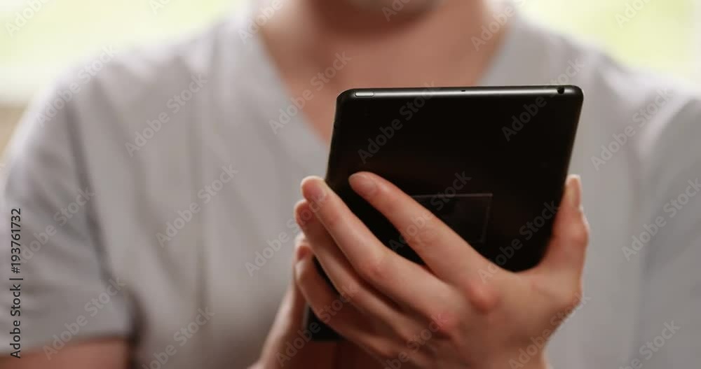 4k, Man using a digital tablet computer and relaxing at home. Closeup. 4k, Man using a digital tablet computer and relaxing at home. Closeup.