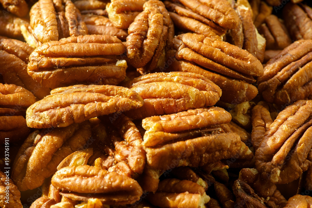 Pecans nuts. A close-up photograph. Unrefined whole kernel Pecans nuts. A close-up photograph. Unrefined whole kernel