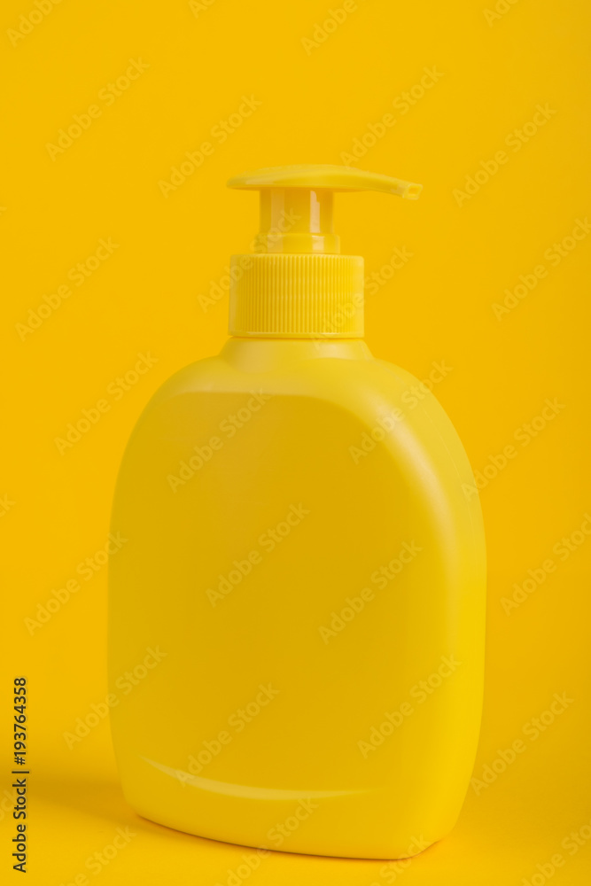 Cosmetic bottle isolated on yellow background. Cosmetic bottle isolated on yellow background.
