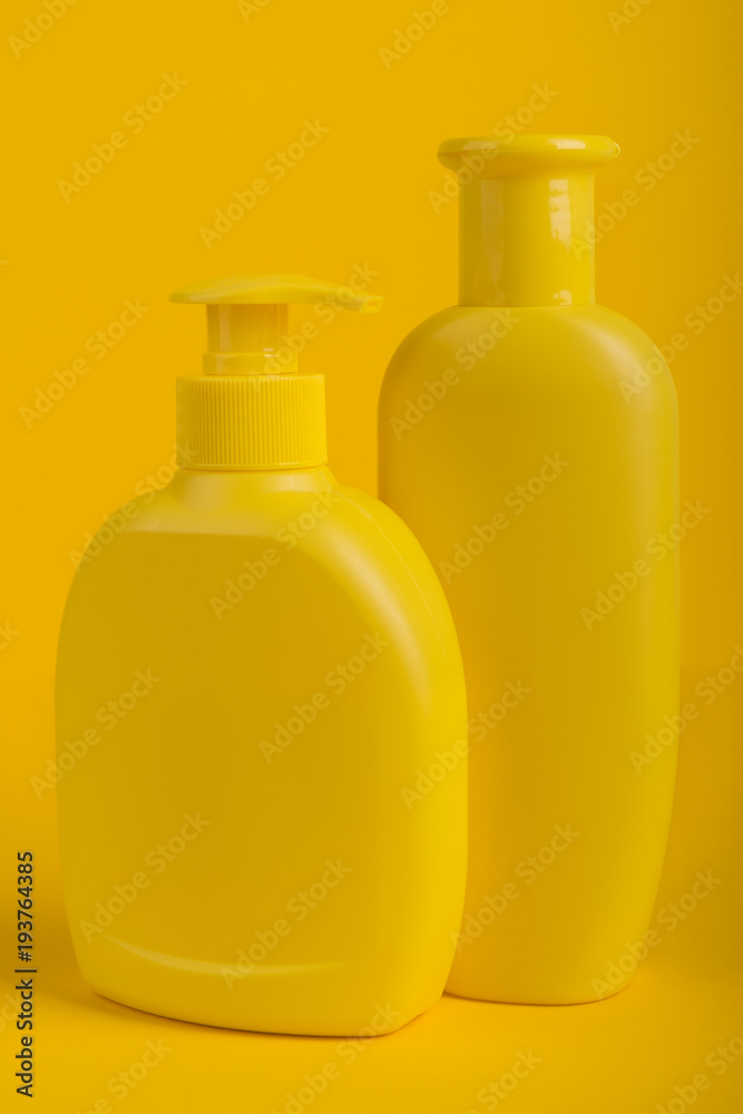 Group Cosmetic Bottles Isolated on Yellow Background. Group Cosmetic Bottles Isolated on Yellow Background.