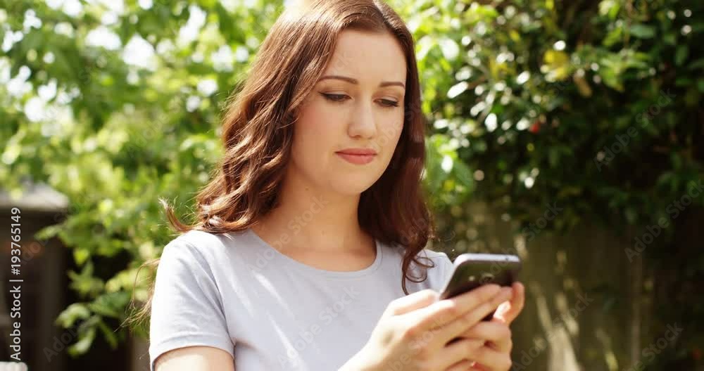 4k,Attractive young woman in the park on her mobile phone. 4k,Attractive young woman in the park on her mobile phone.