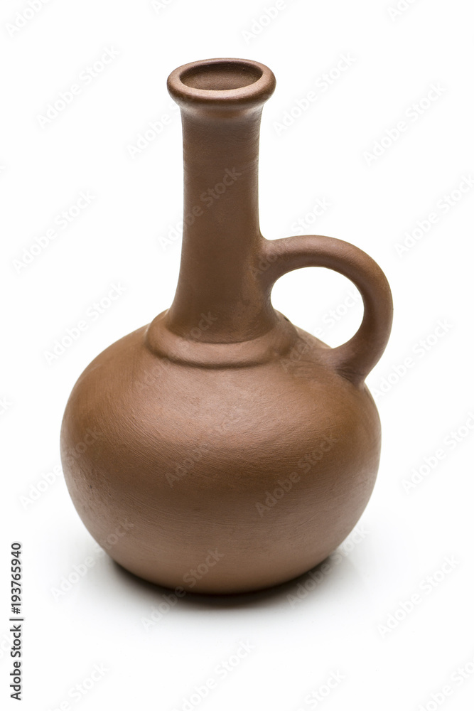 A small brown clay jug close-up on a white background.