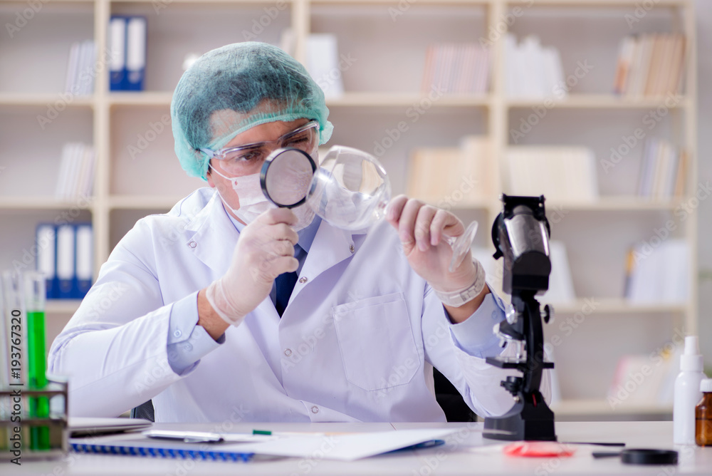 Forensics investigator working in lab on crime evidence Forensics investigator working in lab on crime evidence