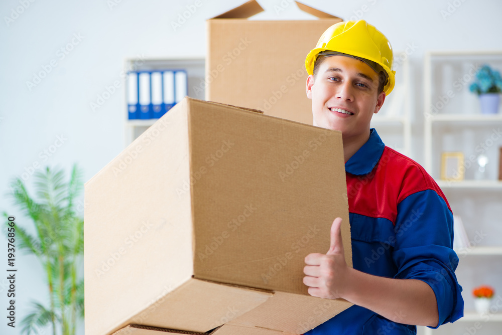 Young man working in relocation services with boxes Young man working in relocation services with boxes