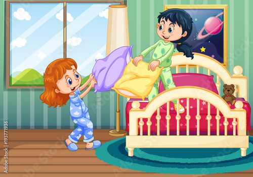 Two girls play pillow fighting in bedroom