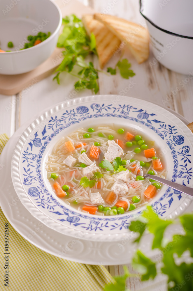 Spring chicken soup noodles, vegetable and toast Spring chicken soup noodles, vegetable and toast