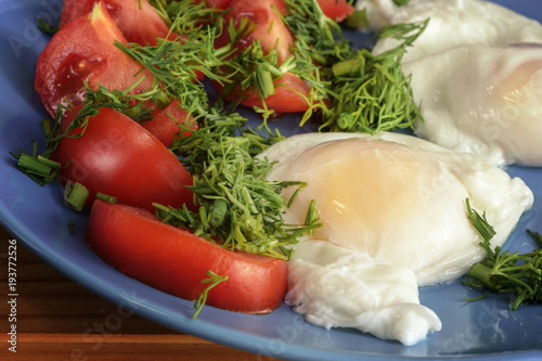 Eggs poached with vegetables, and greens