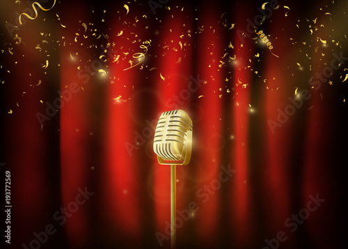 Vintage  gold metal microphone.  Red curtain background with spo